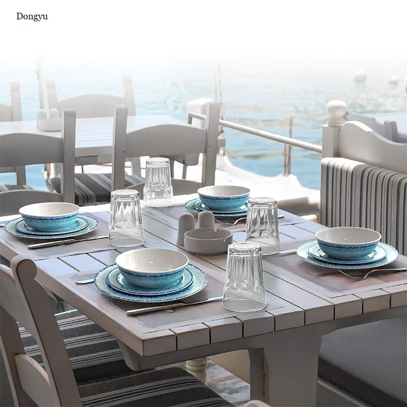 Classic blue and white melamine plates and bowls set on an outdoor patio dining table